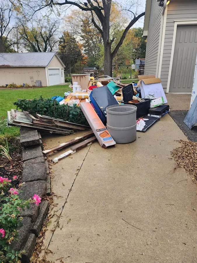 Dumpster being loaded with debris for Residential Dumpster Rental in Bloomington